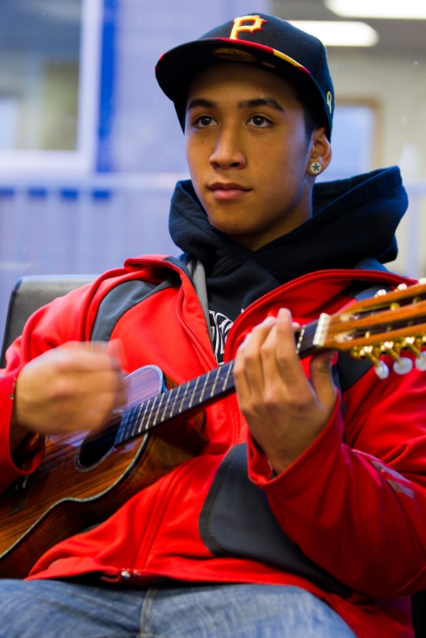 Keda Lee strums his ukulele providing a hint of what awaits in Hawaii for the guests of Alaska Airlines inaugural Bellingham to Honolulu Flight.