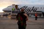 Aukai La'amaikahiki performs a traditional Hawaiian blessing for the inaugural Alaska Airlines flight from Bellingham to Honolulu.