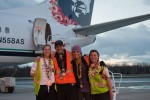 Alaska crew poses in front of their plane.