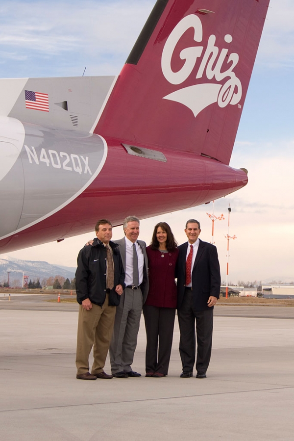 University of Montana and Horizon Air execs take a photo op under the tail