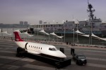 Learjet 85 mockup visits USS Intrepid. The soon-to-be commissioned USS Michael Murphy is docked in the background.