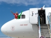 Sir Richard Branson and Green Man poke their head out of the plane.