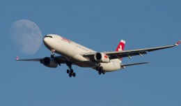 A Swiss Airbus A330 meets the Moon over New York