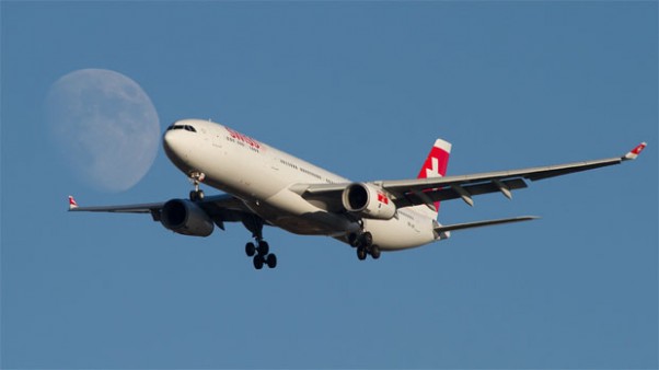 A Swiss Airbus A330 meets the Moon over New York