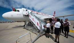 Sir Richard Branson and Green Man poke their heads out of the cockpit window after Virgin America's first arrival in Philadelphia.