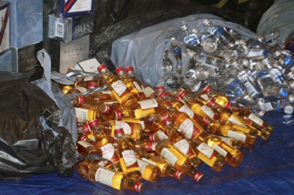 Thousands of the recovered bottles of liquor were displayed at a press conference held by Queens District Attorney Richard Brown. (Photo by Queens DA's Office)