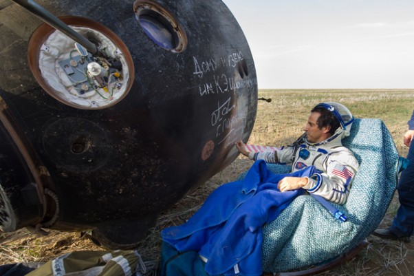 Expedition 32 NASA Flight Engineer Joe Acaba signs the side of his Soyuz TMA-04M spacecraft shortly after he landed with his Expedition 32 crewmates. (Photo by NASA/Carla Cioffi)