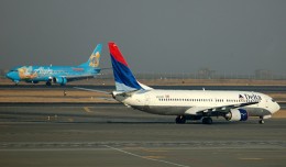 Alaska's Disneyland Boeing 737-400 crosses paths with a Delta 737-800 in Seattle. (Photo by Andrew W. Sieber via Flickr, CC-BY-NC)