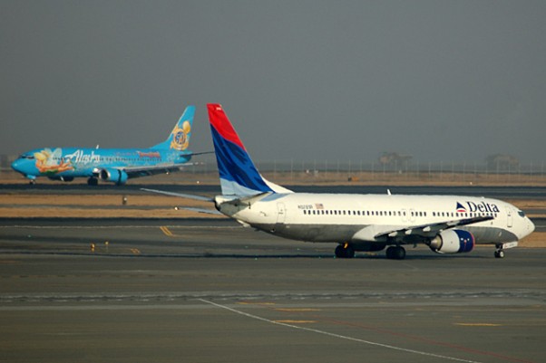 Alaska's Disneyland Boeing 737-400 crosses paths with a Delta 737-800 in Seattle. (Photo by Andrew W. Sieber via Flickr, CC-BY-NC)